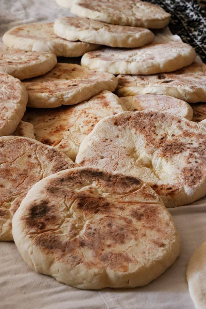 Mastering the First Impression: Your intriguing post title goes here An assortment of freshly baked rustic flatbreads stacked on a table, showcasing their golden brown crusts.